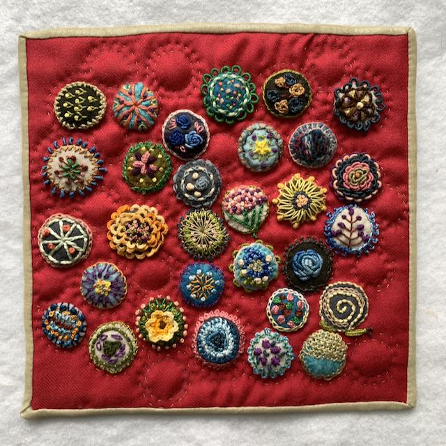 Wool embroidered circles, quilted by Alanna Nelson, 2022.